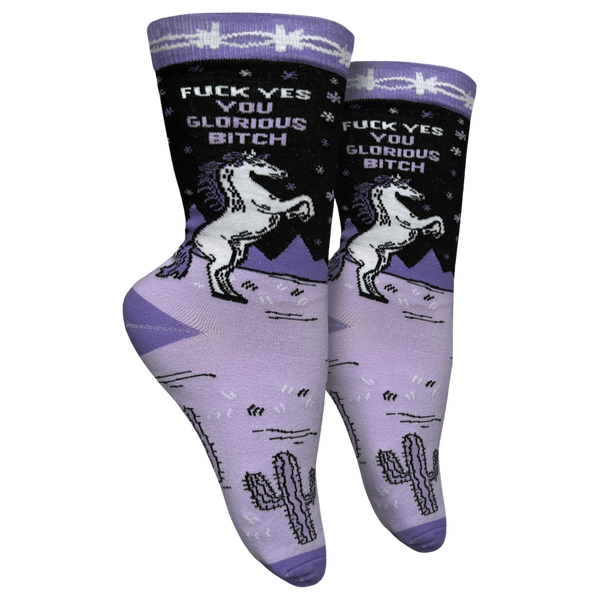 F**k Yes You Glorious B**ch Socks - Small. A pair of socks with a unicorn motif and a bold sweary slogan. Purple legs with deep purple toes, heel and cuff. 