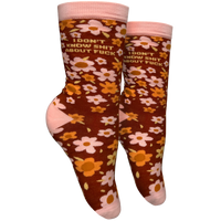 I Don't Know S**t About F**k Socks - Small. A pair of socks with a bold sweary slogan and a bold flowers design. Pink toes, hell and cuff. 