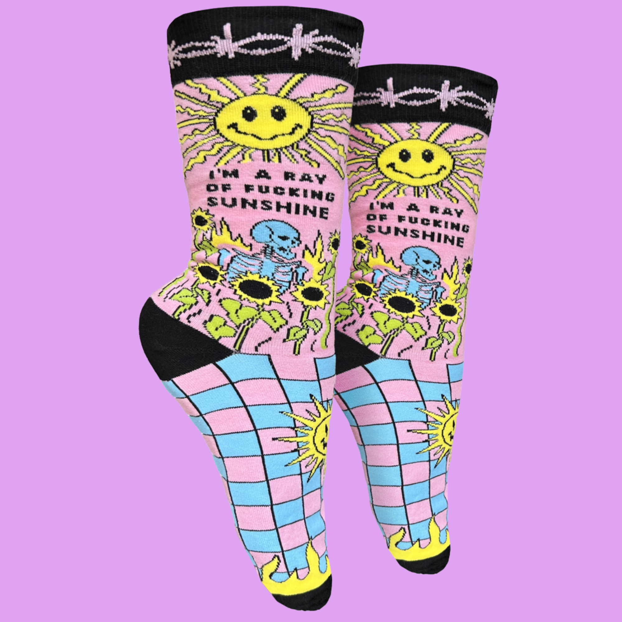 I'm A Ray Of F**king Sunshine Socks - Small. A pair of socks with a psychedelic sun shine pattern in bright blue and pink. Black toes, heel and cuff.