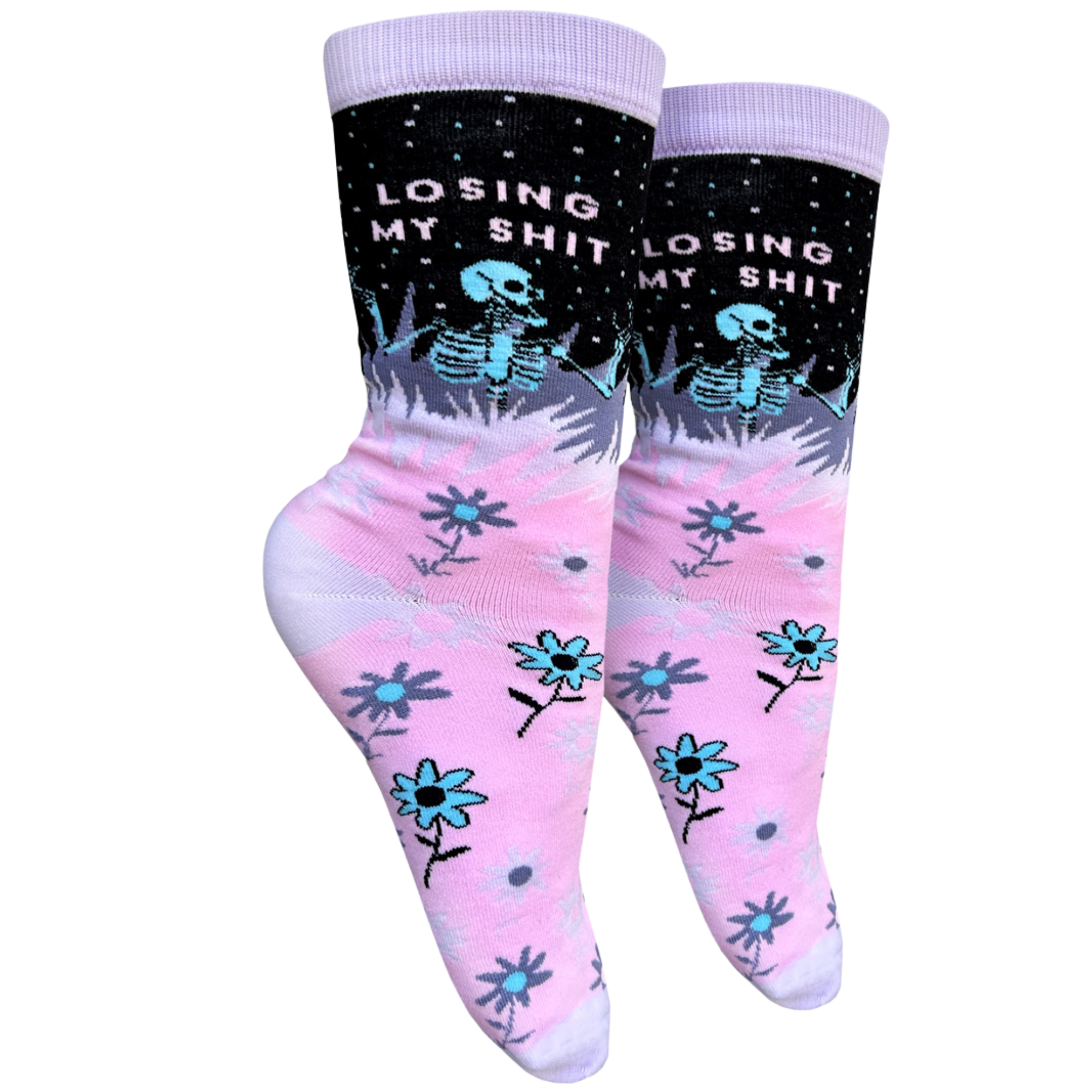 A pink and purple pair of socks with a skeleton and the slogan Losing My S**t on the ankle. Pink heel, toe and cuff.