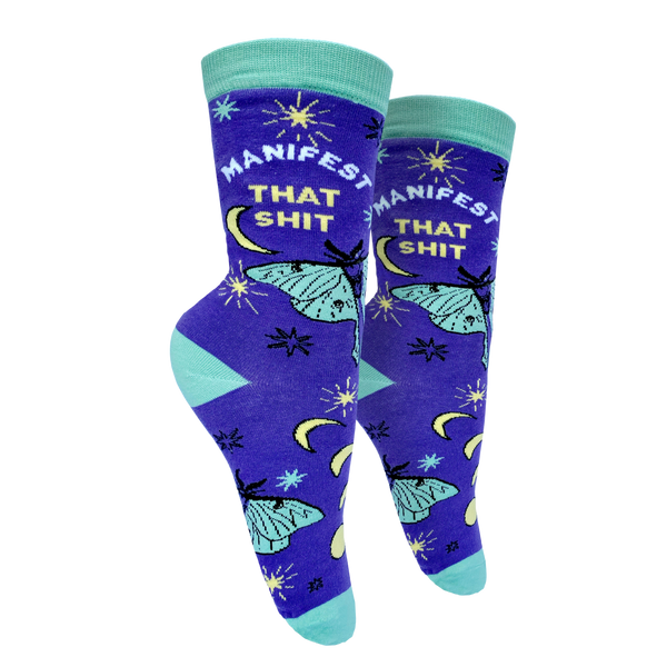 Manifest That S**t Socks. A pair of socks with the slogan Manifest That S**t and a butterfly motif. Purple ankles, turquoise toe, heel and cuff. 