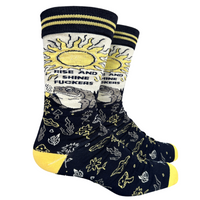 Rise and Shine Socks. A pair of socks with a design featuring a frog, a sunrise and section of scared plants. Yellow toes, heel and cuff.