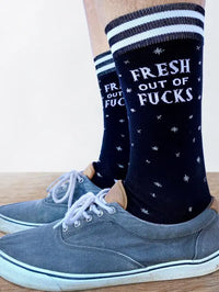 Fresh out of F**ks Socks. A pair of socks with a bold slogan and simple black and purple stars design. Purple toes, heel and cuff.