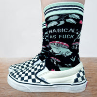 Model wearing a Pair of socks with a fun and sweary slogan. Featuring a magic toad and magic mushroom pattern. Turquoise toe, heel and cuff.