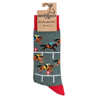 A pair of socks depicting horse racing. Grey legs, red cuff and, heel and toe. In packaging. 