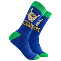 A pair of socks depicting metal horns that say 'Badass Grandad. Blue legs, green cuff, heel and toe. 